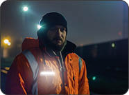 Portrait of young construction worker at night