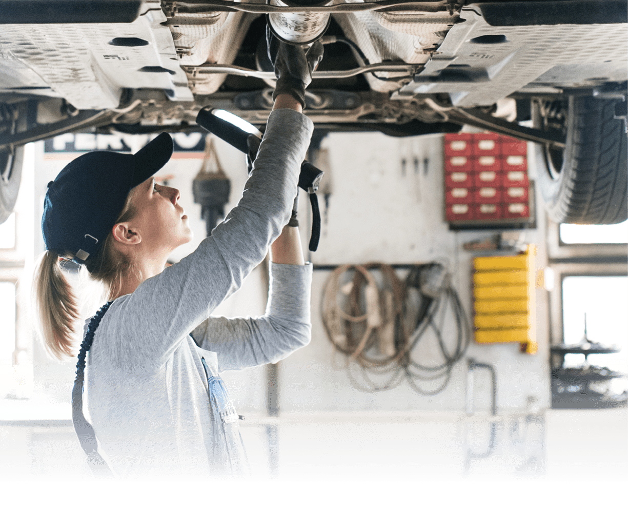 Female mechanic repairing a car. A woman in a garage.