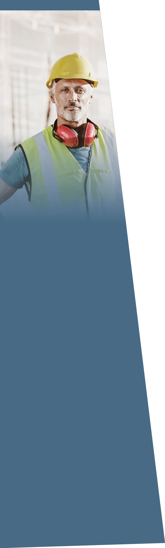 Portrait of confident male architect standing with hands on hips at construction site